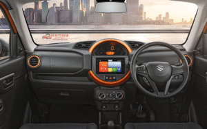 Front and side view of Maruti Suzuki S-Presso compact SUV-styled hatchback in vibrant orange color, parked on urban road
